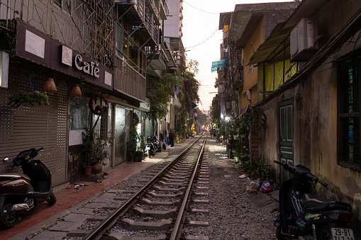 Hanoi, Vietnam, January 2023.  the passage of a train along the tracks between the houses of the old district of the city centre