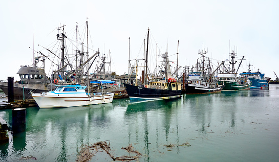 Steveston, BC, Canada - January 4, 2022. Steveston Fisherman's Wharf. Fishing Boats at Steveston Harbor in rainy weather.