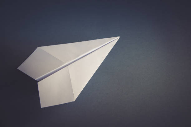 istock White paper plane origami isolated on a grey background 1463343354