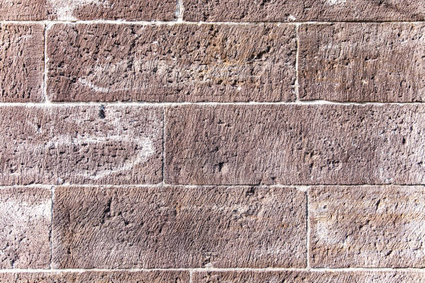 Full frame of old brick and stone historic building wall with grunge texture.
