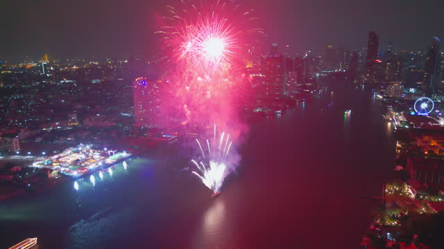 Aerial drone point of view Multi colors Fireworks Displays over the Sky City. New Year Eve. Skyscraper and Cityscape Celebrate Night Lights