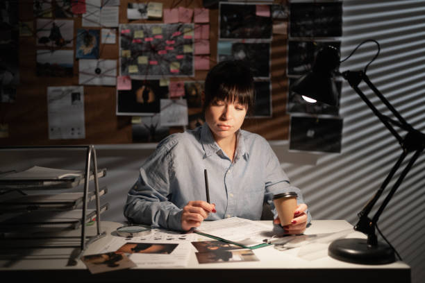 istock Female detective working in her office drinking coffee and thinking 1463346917