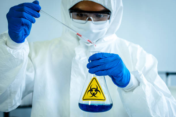 istock Lab Technician in Personal protective equipment  PPE suit Vaccines testing of Virus 1463348132