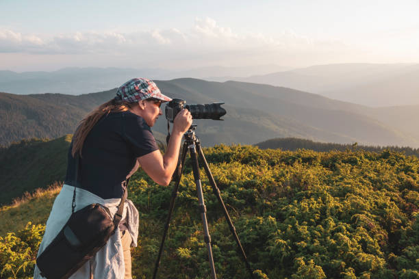 istock Woman photographer with tripod 1463348178
