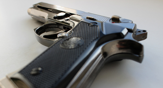 An automatic pistol handgun with a gun safe and shooting equipment.