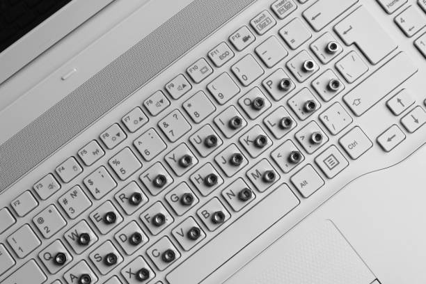 istock Metal nuts overlap symbols on a white computer keyboard top view stock photo 1463351254