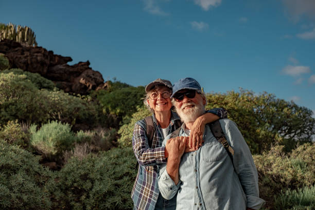 istock Smiling old senior couple enjoying outdoor excursion in mountain environment. Beautiful active elderly people having healthy lifestyle in retirement 1463352961
