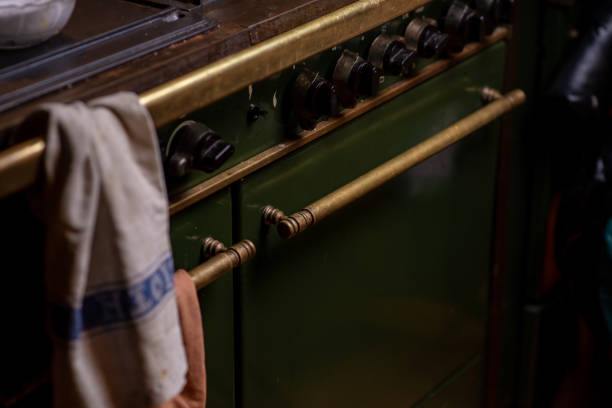 old fashioned gas stove dark green. part of home cooking. - antique furniture old old fashioned imagens e fotografias de stock