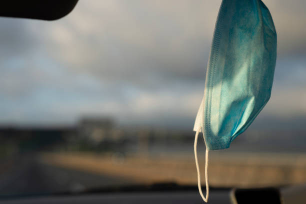 istock View from inside a car driving on motorway, facemask hanging inside the car. Auckland. 1463356576