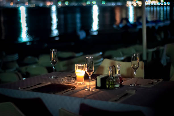Table with candles on the beach of the evening cafe.