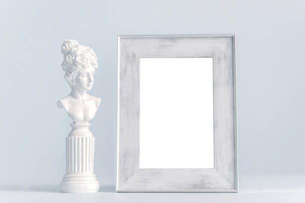 istock An empty frame stands on the table and a figurine. Close up poster frame mockup in blue color, minimalist interior. 1463357211