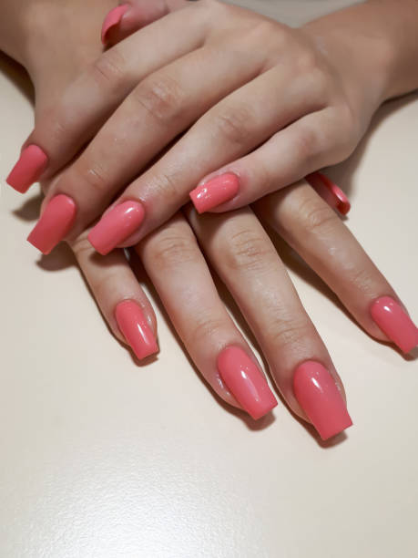 istock Acrylic nail extension, manicure, nail correction, hands in the foreground. Reflective design. 1463360236
