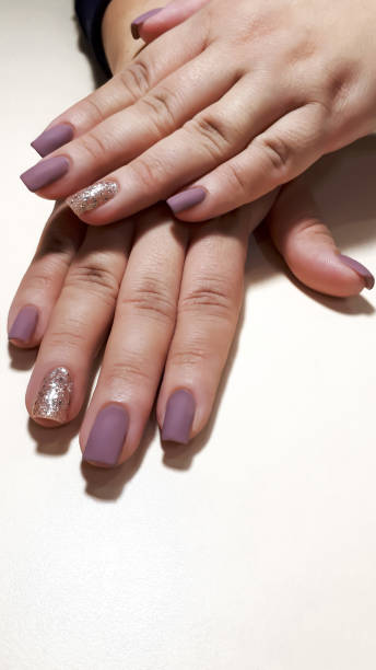 istock Acrylic nail extension, manicure, nail correction, hands in the foreground. Reflective design. 1463360310