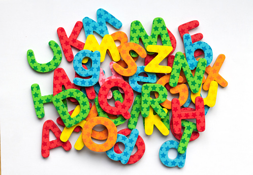 Multicolored alphabet magnets letters, colorful ABC on white background. Children education, school and preschool background.