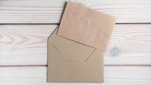 Sealed closed brown craft envelope appearing. Coarse twine untying, envelope opening, blank craft paper showing up.