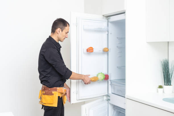 istock Male technician repairing broken refrigerator in kitchen 1463364980
