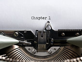 The word chapter 1 written with a vintage typewriter. Storytelling, book writing or authorship concept.