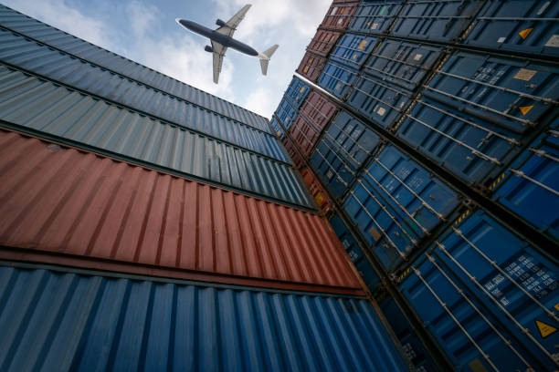 istock Freight airplane flying above overseas shipping container . Logistics supply chain management and international goods export concept . 1463365840