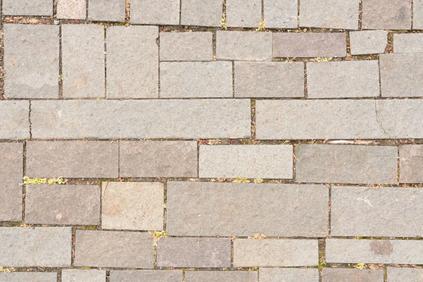 Perspective view brick stone pavement on the ground for Street Road. Vintage ground flooring square pattern texture for mock up.