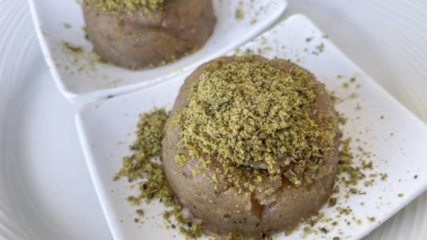 istock Traditional Turkish halva dessert with pistachios on white plate 1463370206
