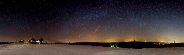 istock Panoramic shot of a starry night sky over landscape 1463370479