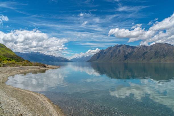 istock Lake Hawea on a sunny day with water reflecting hills and cloudy sky 1463372783