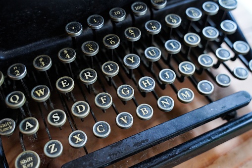 A closeup of a vintage typewriter keyboard letters