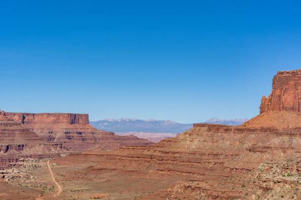 istock Peaceful desert landscape in a canyon with dry brown fields and rocky cliffs under a clear blue sky 1463374566