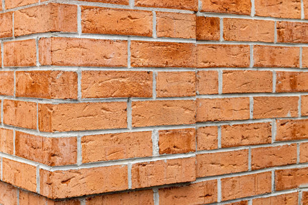 istock Weathered building wall made of red bricks 1463374804