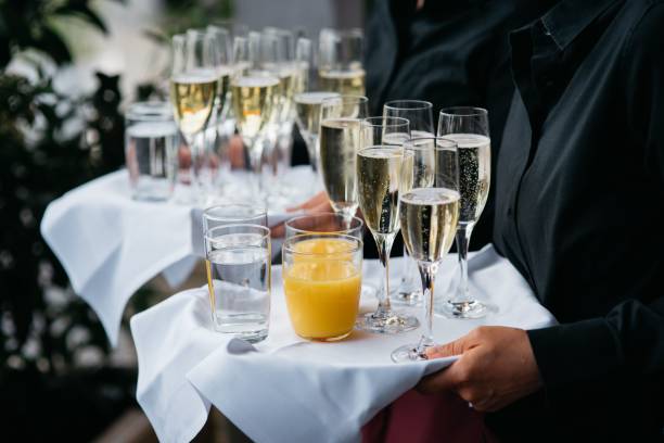 istock Waiter with sparkling wine, water and orange juice 1463375655