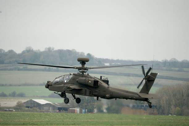 istock Military helicopter landing in a field 1463376363