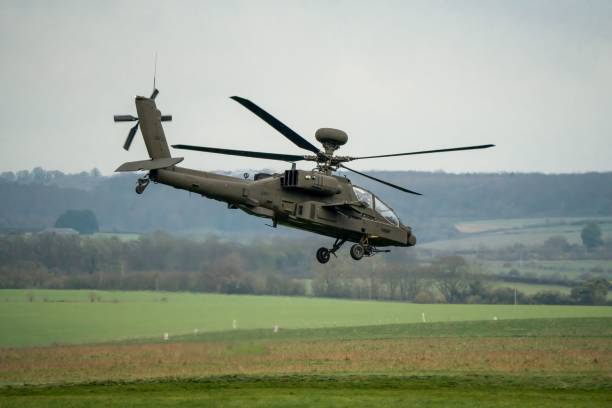 istock Military helicopter landing in a field 1463376375