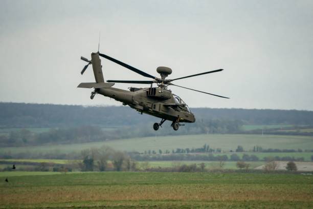 istock Military helicopter landing in a field 1463376384