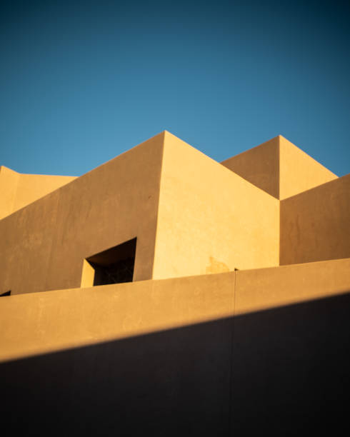 istock Vertical shot of a modern building under a blue sky and sunlight 1463378210