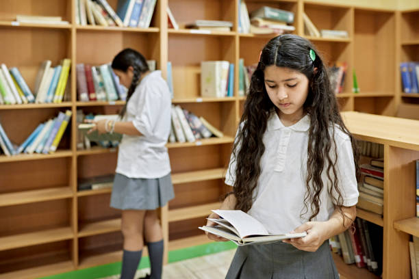 Hispanic schoolgirls at library