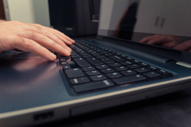 istock Man typing on a keyboard with letters in Hebrew and English 1463378732