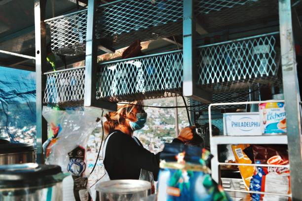 woman wearing medical mask and serving street food - mexico dress market clothing imagens e fotografias de stock