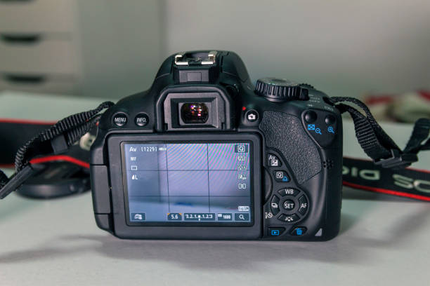 istock Closeup of a modern black camera on a white table 1463378865
