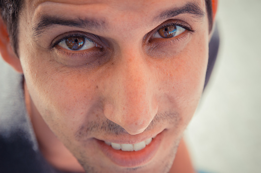A Close up top view shot of a young man looking at the camera