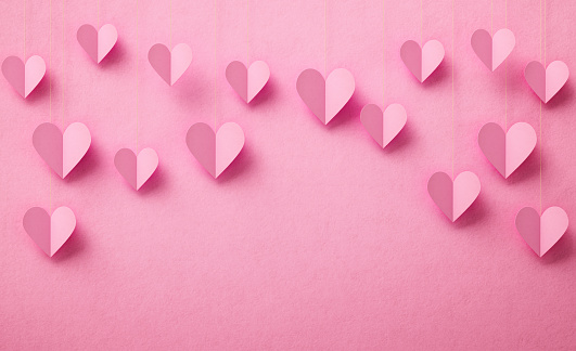 Pink heart shapes on pink background. Horizontal composition with copy space.