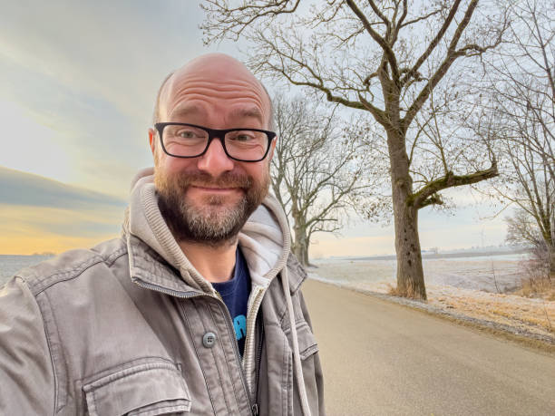 Happy Man in Bavarian Nature during Winter Happy Man with smile during a winter walk with Bavarian Nature background bald guys with beards stock pictures, royalty-free photos & images