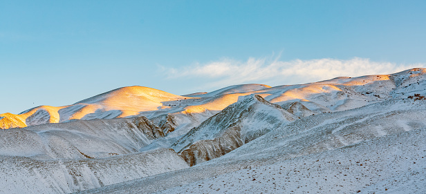 A beautiful landscape of snow-covered mountains under the sunlight - great for wallpapers