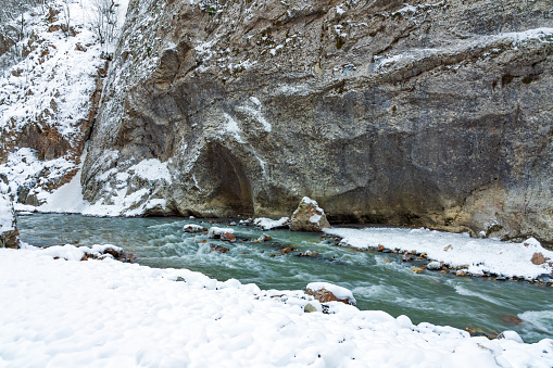 A photo of a fast motion mountain river in the gorge during winter season