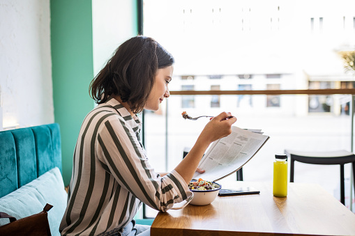 Attractive young woman sitting at a restaurant