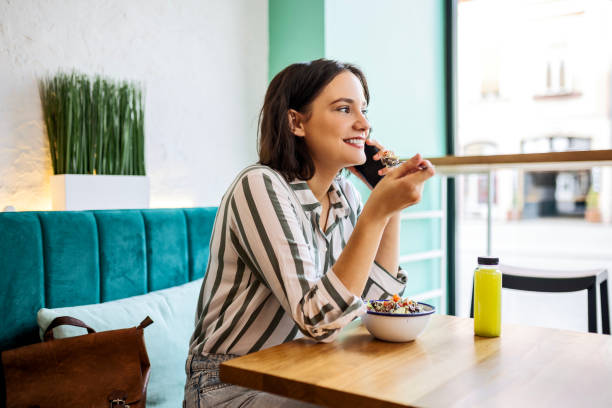 istock Young woman using phone on a lunch break 1463382165
