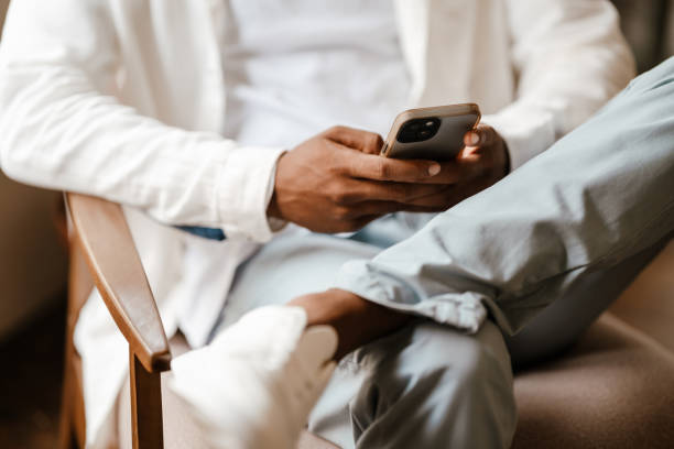 istock Young african american man using cellphone while sitting in cafe 1463382948