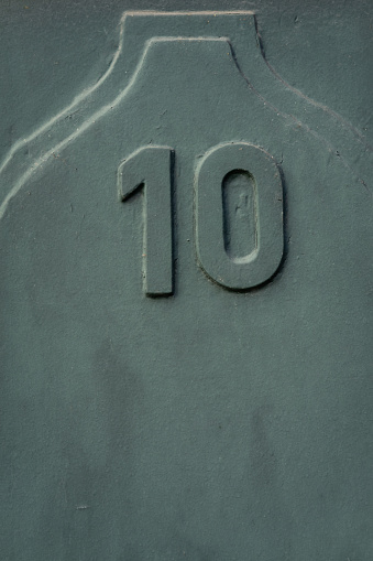 Even number ten, 10, in weathered green colour with copy space. Aged look.
