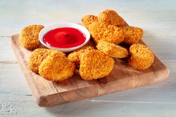 istock Chicken nuggets with ketchup on a wooden board 1463389557