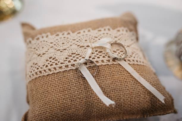 istock Closeup of two wedding rings on a laced pillow, ready to a wedding 1463389631