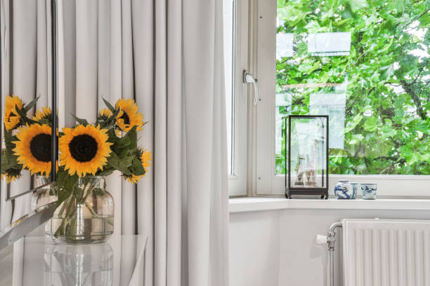 istock Closeup shot of decorative flowers and objects by the window 1463389988